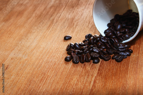 Roasted coffee beans with a wood background