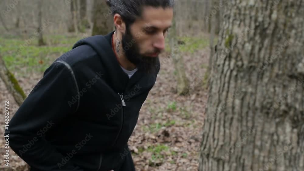 The fighter trains a punch and beats his fists in the tree The fighter trains a punch and beats his fists in the tree