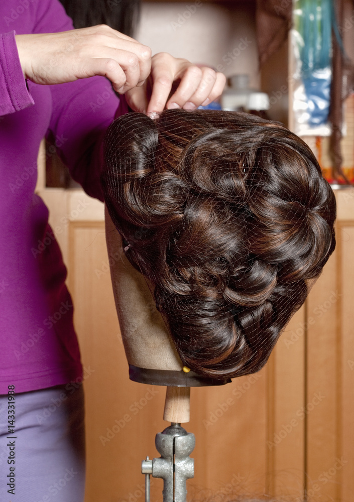 Professional Wig Maker Working in her Workshop. Professional Wig Maker Working in her Workshop.