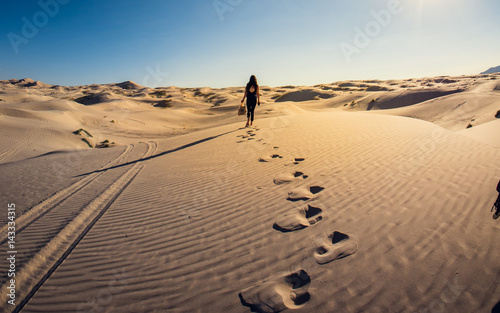 Girl walking into a sand desert  Mexico