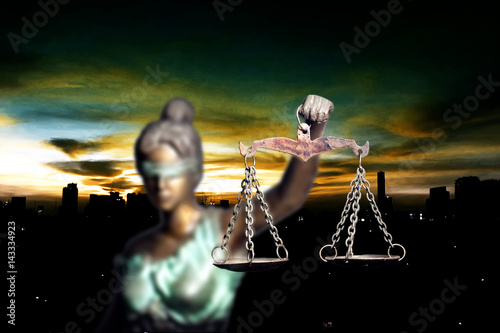 Obraz na plátne Lady Justice and city in dawn time
