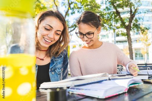 Photography Girls studying together at park
