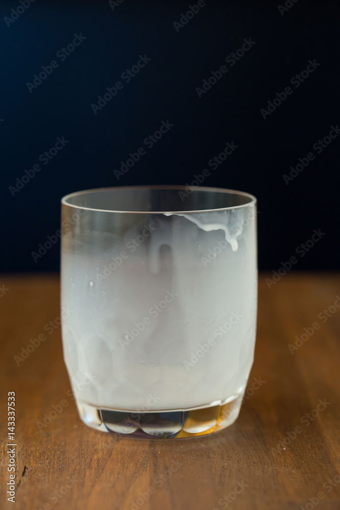 Empty hot milk cup after drink on wood table Empty hot milk cup after drink on wood table