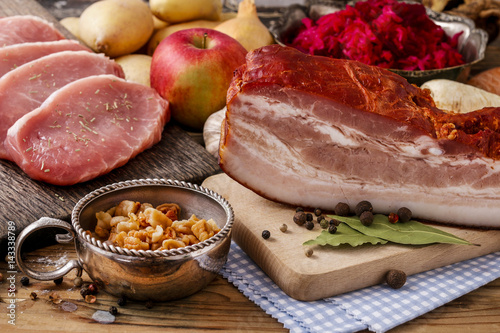 Different kinds of meat and vegetables on wooden table.