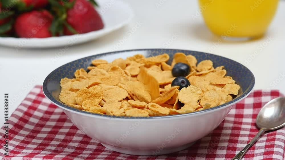 Breakfast. Berries falls down into bowl with cornflakes Breakfast. Berries falls down into bowl with cornflakes