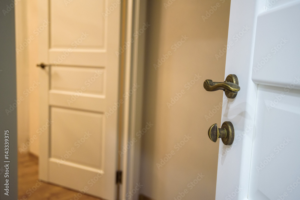 Modern opened white wooden door indoors Modern opened white wooden door indoors