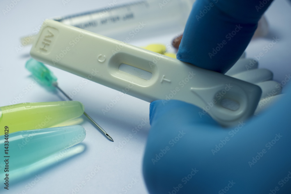 Gloved Hand Holding HIV Rapid Test Gloved Hand Holding HIV Rapid Test