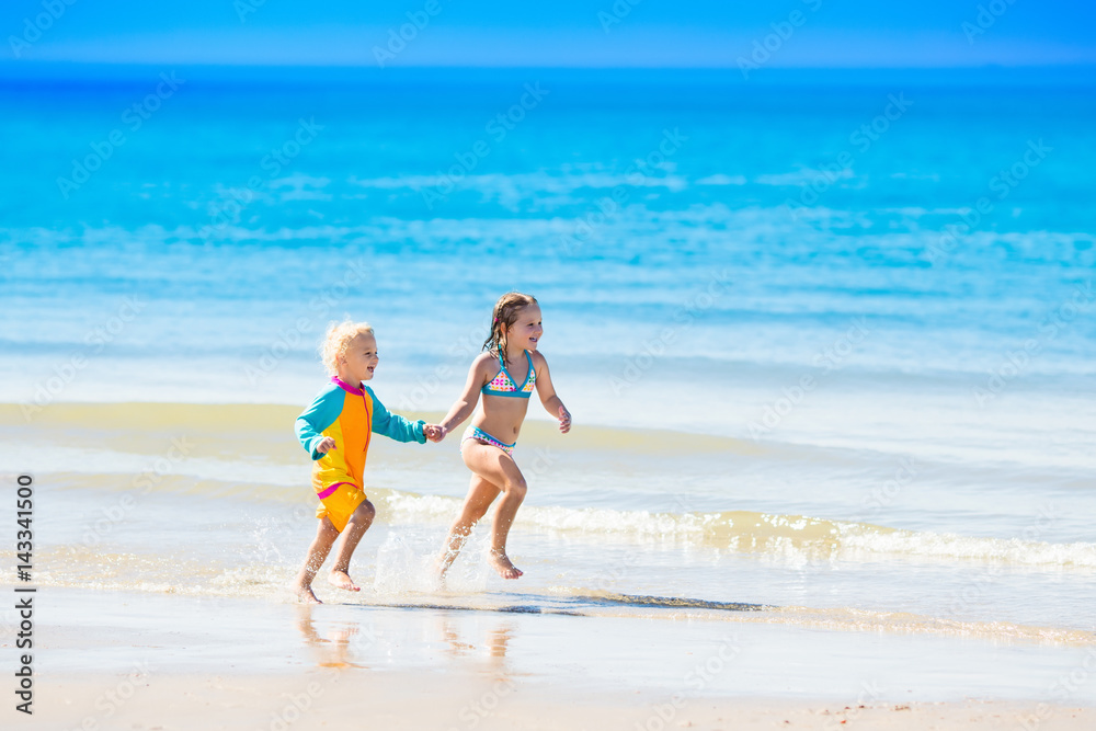 Kids run and play on tropical beach