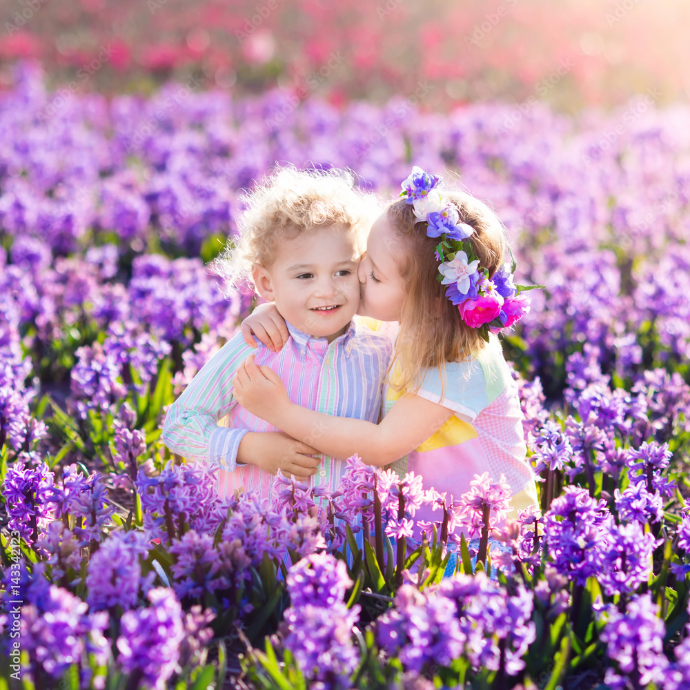 Kids playing in blooming garden with hyacinth flowers Kids playing in blooming garden with hyacinth flowers