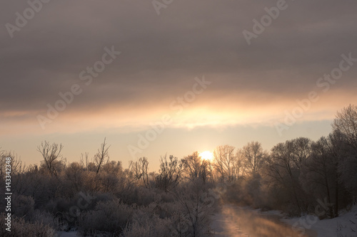 Morning sunrise over the river in winter