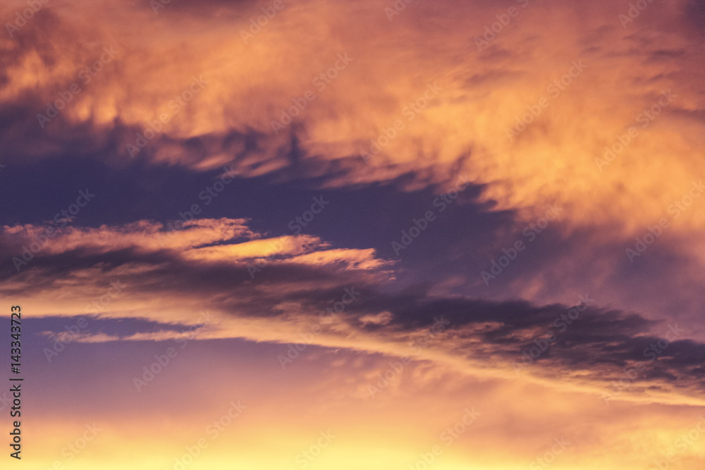 Abstract picture of a burning sunset sky in yellow, orange and purple