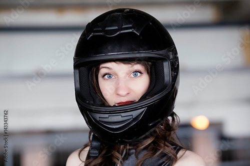 Young Vibrant Intense Girl in black Face Motorcycle Racing Helmet © ribalka yuli