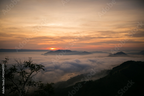 Thailand sunrise mist foreground and mountains in Mekong river