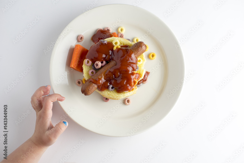 child reaching for hot dog and cereal child reaching for hot dog and cereal