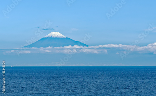 Sea approach to Shimizu, Japan with the sunlit snow capped peak of Mt. Fuji gleaming in the background © teesixb