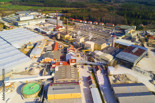 Aerial view of factory plant producing ceramic tiles from raw kaolin material. Top view of industrial area.