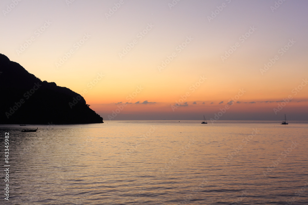 golden sunset at Koh Phi Phi with sailing boats