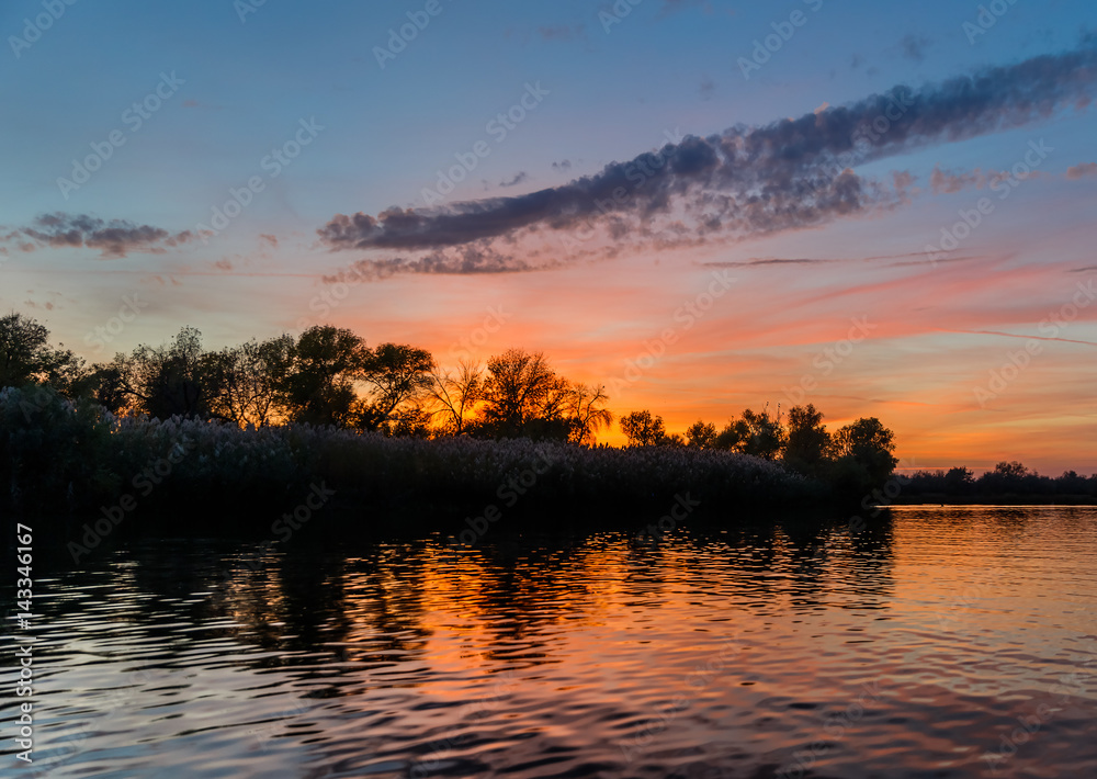 Evening sky scene with dramatic red clouds in the Delta of the Volga River, Russia