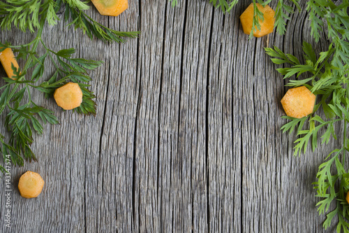 carrots cut into pieces on the old wooden table
