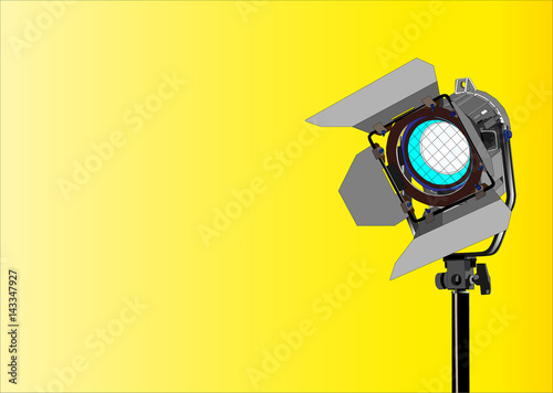 Spotlight on a stand on a yellow background.