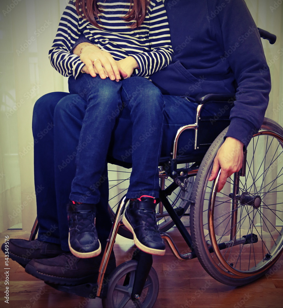 Obraz premium disabled parent in a wheelchair with her baby