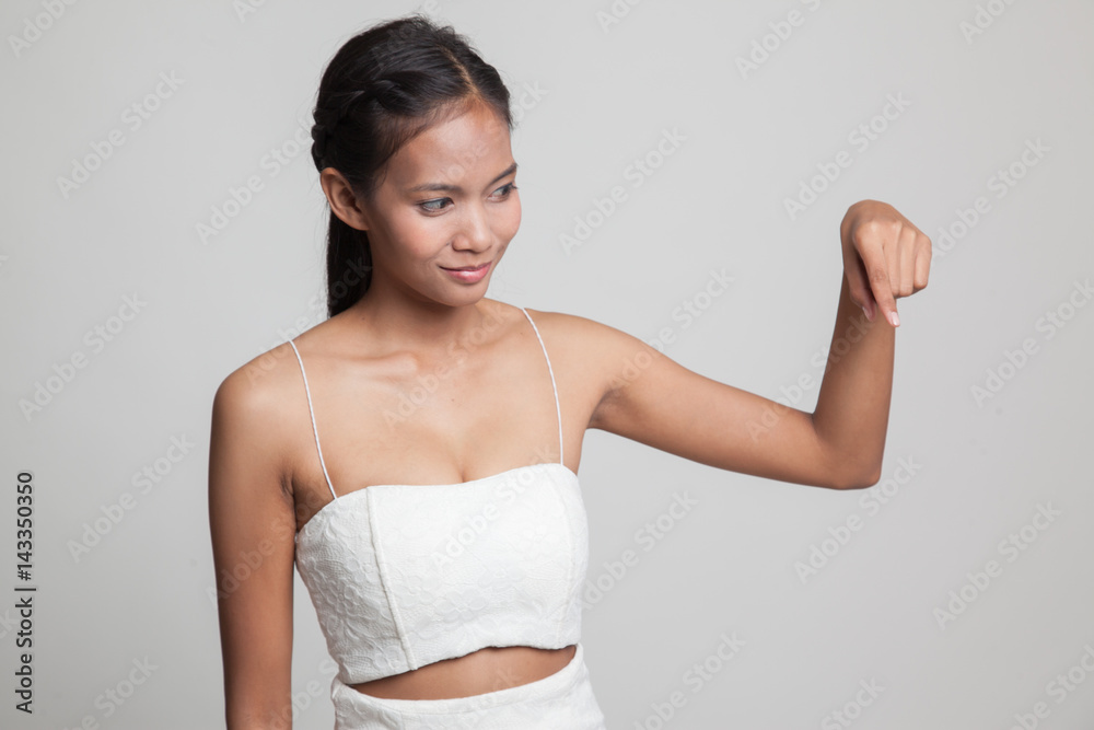 Beautiful young Asian woman point down to blank space. Beautiful young Asian woman point down to blank space.