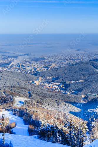 View from Tserkovka mountain to the resort town of Belokurikha in winter, Altai, Russia photo