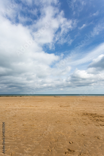 Sandy beach with blue sky at low tide at Benllech in Anglesey  North Wales