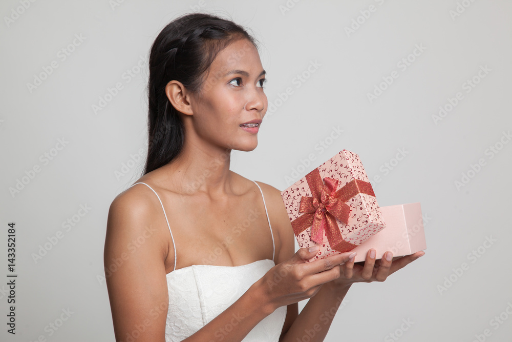 Young Asian woman open a gift box. Young Asian woman open a gift box.
