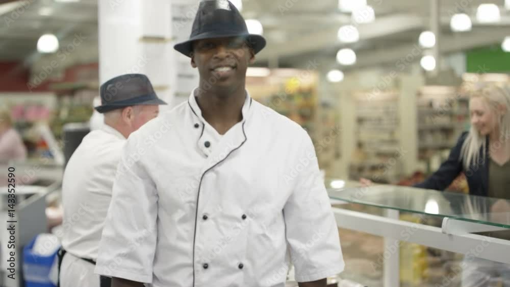  Portrait smiling worker behind supermarket deli counter