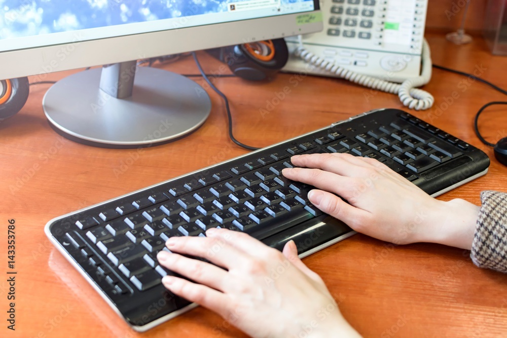 Female office worker, typing on a keyboard Female office worker, typing on a keyboard