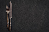 cutlery fork and knife on a black surface