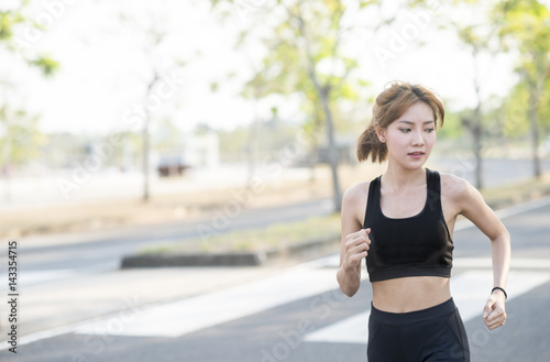 young sporty woman running in park