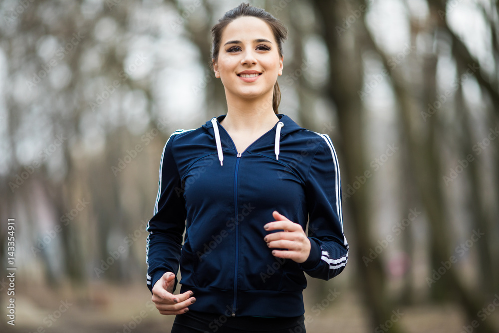 Young woman running and training in park outdoors Young woman running and training in park outdoors