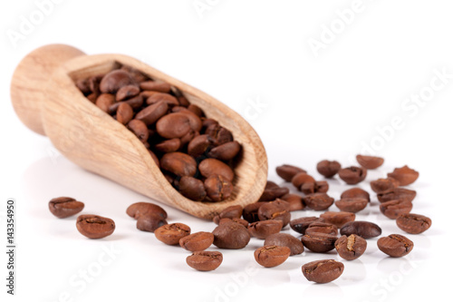 coffee beans in a wooden scoop isolated on white background