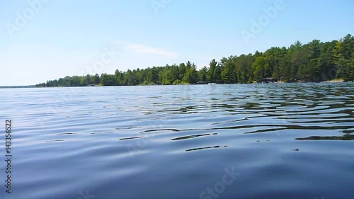 Low angle while boating around Minnesota lake on sunny day.