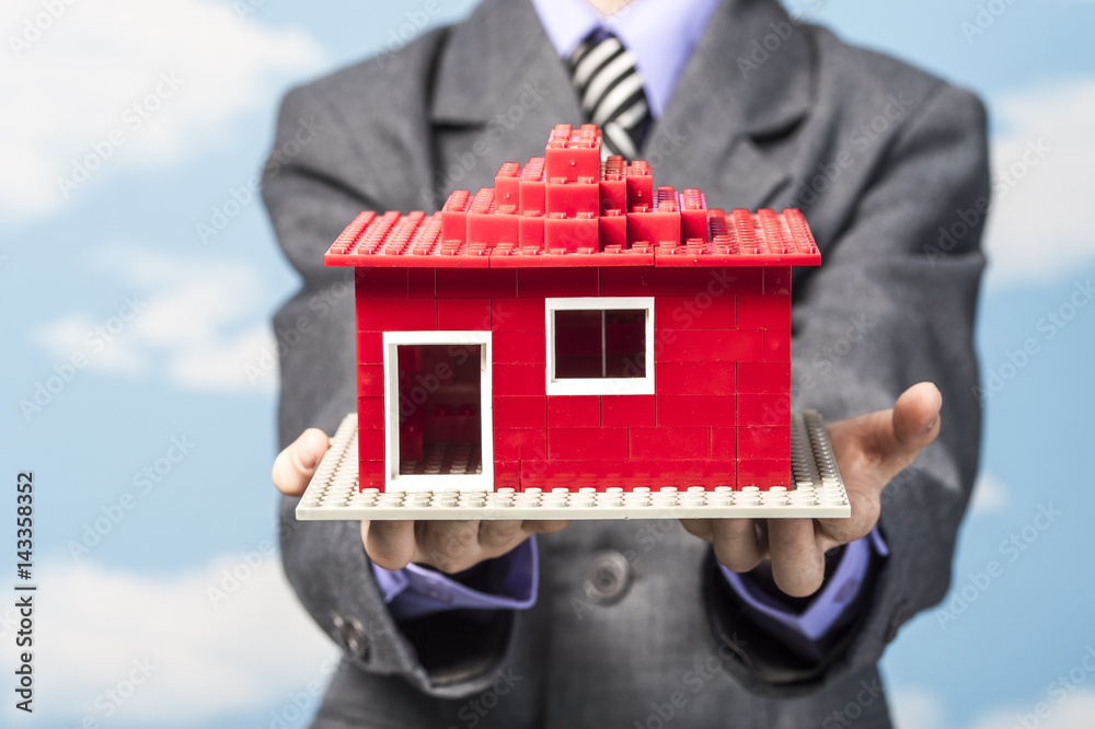 boy in helmet and jacket keeps built from the designer house Stock