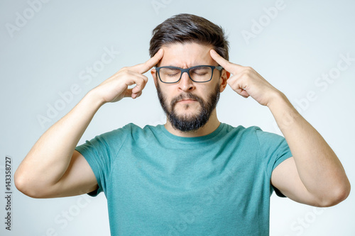 Depressed handsome bearded man touching having a headache