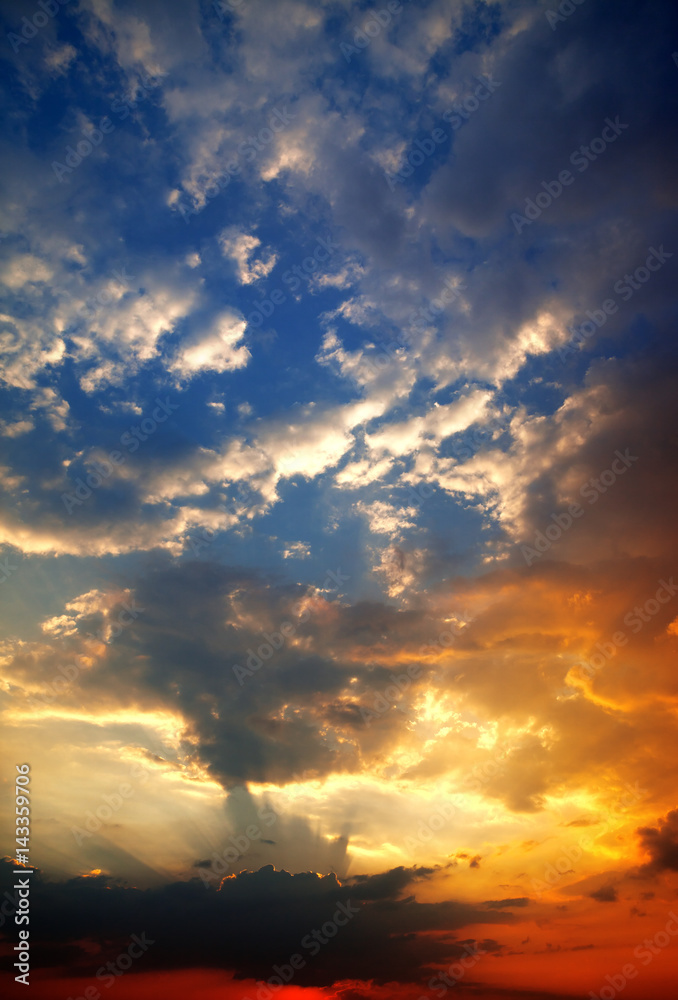 Multicolor sunset sky with clouds and sun rays