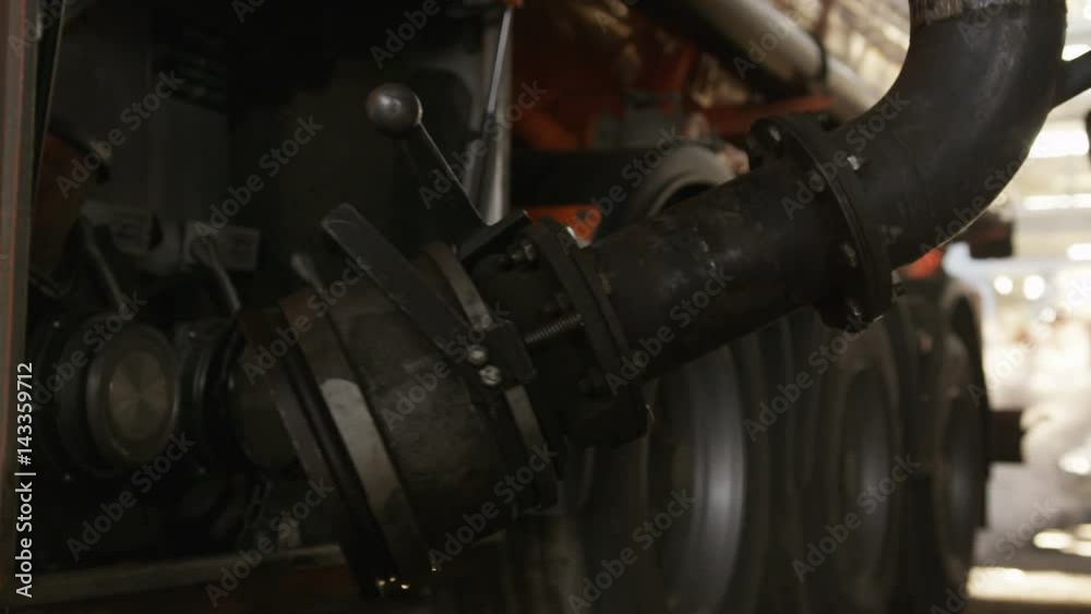 Worker Fills Fuel Truck with Steel Pipe Equipment
