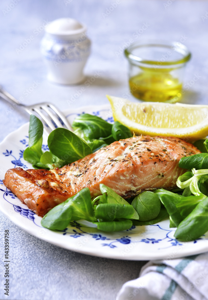 Grilled organic salmon with salad leaves.