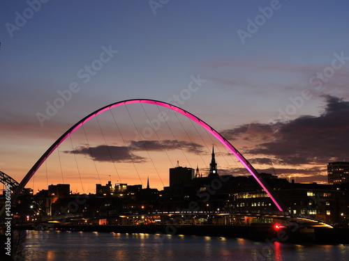 Newcastle upon Tyne, England, United Kingdom. The Gateshead Millennium Bridge and its colors durind evening time