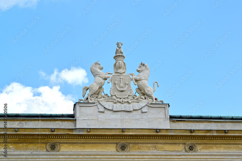 Sculptural composition of the coat of arms of noblemen Urusky on the building of the palace. Warsaw, Poland