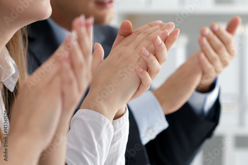 Close up view of business seminar listeners clapping hands
