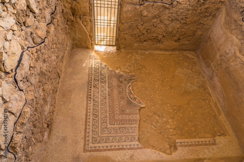 The surviving part of the ancient mosaics and its pattern in the floor in fortress of Masada in Israel photo