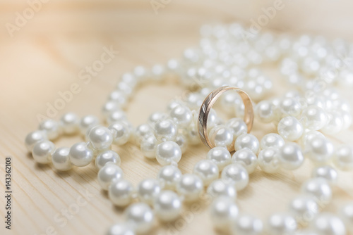 Wedding ring on pearl beads
