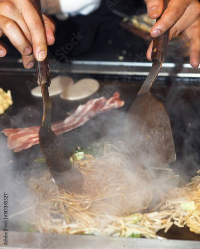 Okonomiyaki being prepared at the table, at Dotombori, Osaka, Ja