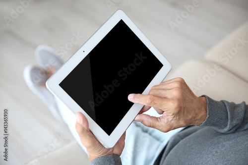 Senior man with tablet, closeup
