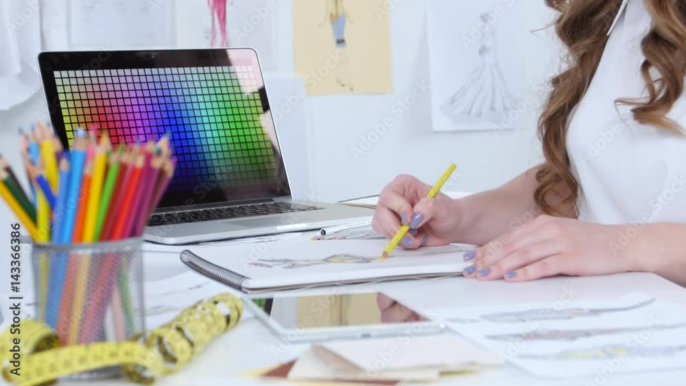 Artist sits in her study, sketches a new collection. Close up Artist sits in her study, sketches a new collection. Close up
