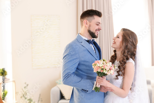 Happy wedding couple at home